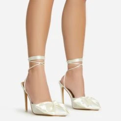 EGO Bowdown Lace Up Bow Detail Pointed Toe Stiletto Heel In Cream Satin