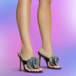 EGO Bouquet Oversized Diamante Rose Detail Thong Strap Square Toe Stiletto Heel Mule In Black Faux Leather